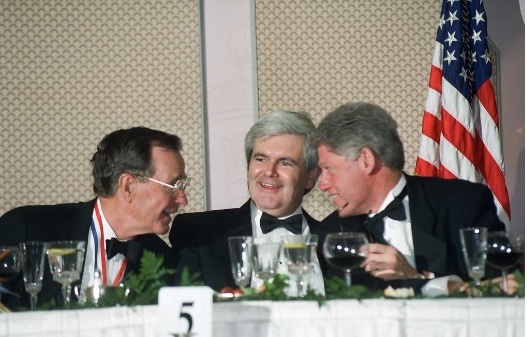 former U.S. Presidents George H.W. Bush and Bill Clinton alongside former House Speaker Newt Gingrich seated together at alfalfa dinner table.